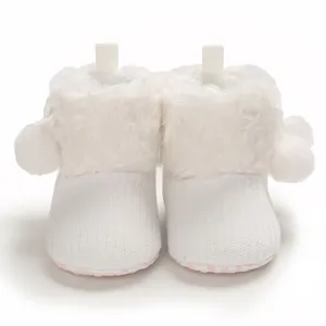 White fuzzy baby boots with cute pom-pom and knitted texture detail