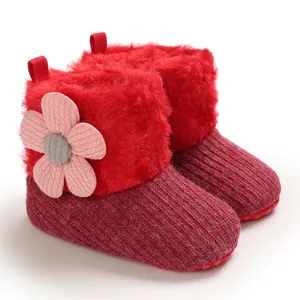 Cozy red knitted baby winter boots with soft faux fur trim and cute flower detail