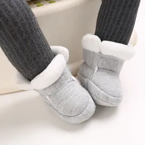 Close-up van grijze baby-katoenen schoentjes met zachte zool en warme witte voering van imitatiebont