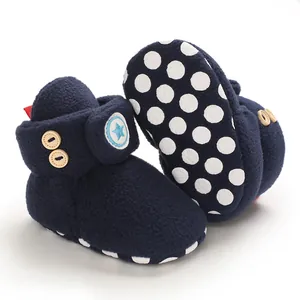 Dettaglio degli scarponcini da neve per neonato in pile blu navy con suole antiscivolo.