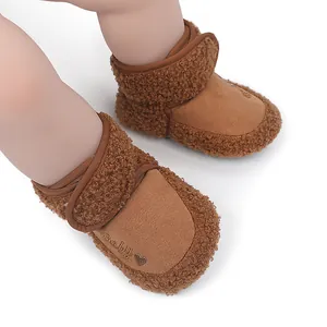 Close-up of cozy brown baby winter boots featuring soft teddy fleece trim and embroidery