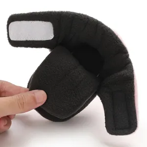 Close-up of soft-soled color-blocked baby fleece shoes showing the velcro strap closure
