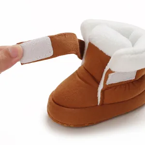 Detailweergave van bruine baby katoenen slofjes met warme pluche voering en klittenband