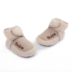 Close-up shot of cozy beige baby fleece boots featuring cute 'Baby' heart embroidery detail