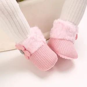 Close-up of pink fleece-lined baby snow boots with soft anti-slip soles