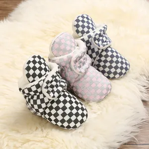 Cozy checkered baby fleece boots in pink and blue for winter warmth.