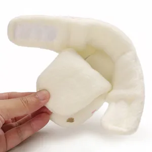 Detailed view of soft plush baby snow bootie showing Velcro strap and flexible white material