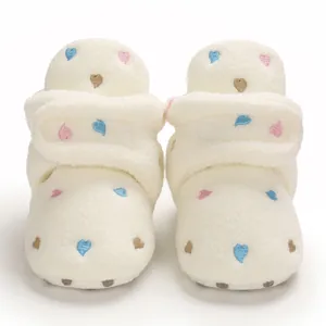 Detailed view of plush baby winter boots with colorful embroidered heart patterns