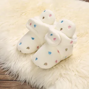 Adorable warm plush baby booties with colorful heart embroidery detail for infants