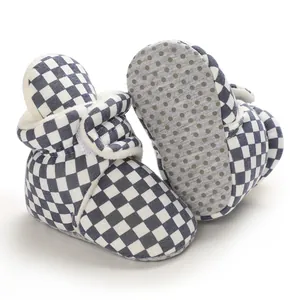 Detail view of checkered baby winter boots showing fleece lining and anti-slip sole