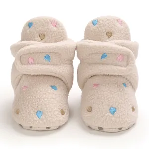 Detailed front view of soft fleece baby winter boots with colorful embroidered hearts