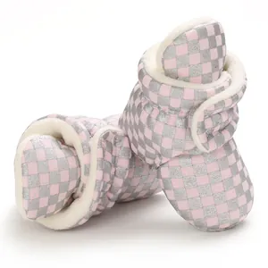 Soft pink silver checkered baby snow boots with warm white faux fur lining details.