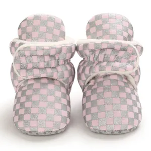 Detailed front view of pink and silver checkered infant boots with soft plush lining