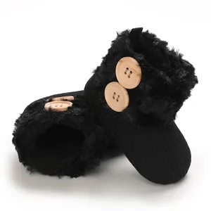 Cozy black infant winter boots featuring soft faux fur lining and wooden button details