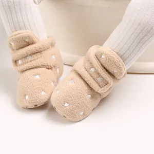 Detail view of warm camel fleece baby shoes with embroidered hearts and soft lining