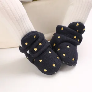 Cozy black fleece baby snow boots with golden leaf patterns for winter warmth and comfort.