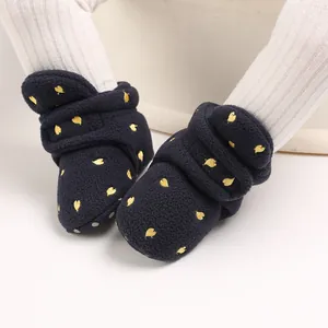 Close-up of navy blue baby winter fleece boots with yellow heart embroidery detail
