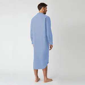 Rear view of a man wearing a light blue long-sleeved traditional style robe nightshirt