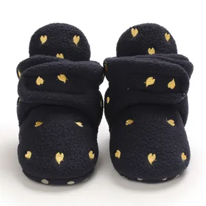 Detailed front view of navy blue fleece baby snow boots with embroidered gold hearts