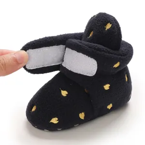 Detailed view of black fleece baby winter boot showing adjustable velcro closure