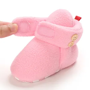 Dettaglio dello stivaletto da neve in pile rosa per neonati con chiusura a velcro