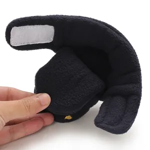 Close-up of soft black fleece baby bootie showing the flexible material and texture