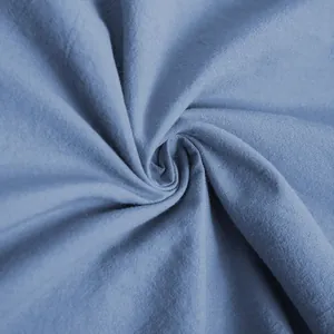 Macro close-up of dusty blue breathable fabric texture with natural woven details.