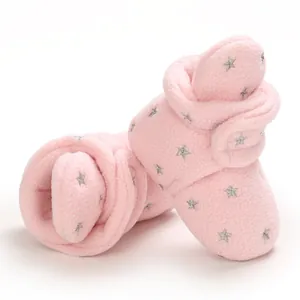 Detailed close-up of pink fleece baby booties featuring silver star embroidery on white background