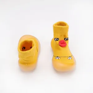 Close-up view of yellow baby knit walker shoes with cute cartoon duck face detail