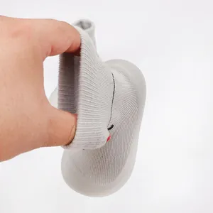 Close-up of flexible opening on grey knit baby walker shoe with soft rubber sole
