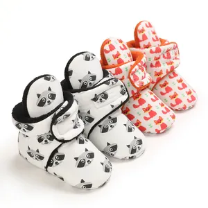 Detail view of cute cartoon baby booties with raccoon and fox prints for 0-1 year olds