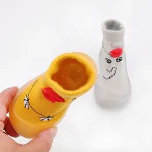 Close-up of breathable baby knit walking shoes with cute cartoon duck face design
