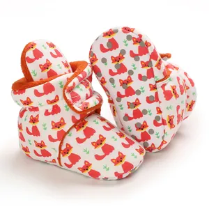 Detailed view of baby booties with cute cartoon fox pattern and anti-slip dotted sole