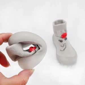 Demonstration of flexible soft rubber sole on cartoon baby knitted walking shoes