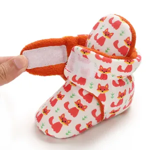 Close-up detail of soft baby cotton bootie with cute fox pattern and velcro closure
