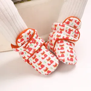 Close-up of soft baby cotton shoes featuring an adorable orange fox pattern design.