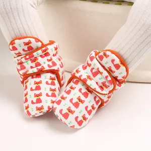 Detailed view of soft cotton infant booties featuring cute orange cartoon fox patterns