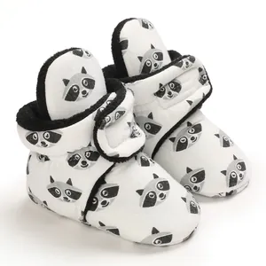 Detailed view of raccoon print baby plush booties with soft lining