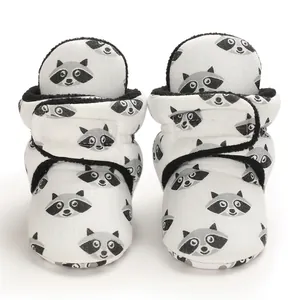 Close-up of baby raccoon pattern cotton shoes with soft black fleece lining and velcro