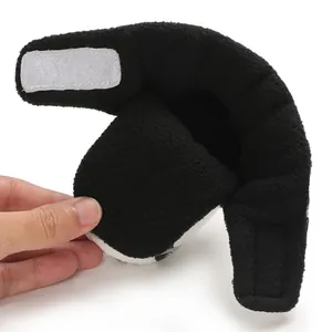 Detailed close-up view of black fleece baby shoe featuring adjustable Velcro strap closure