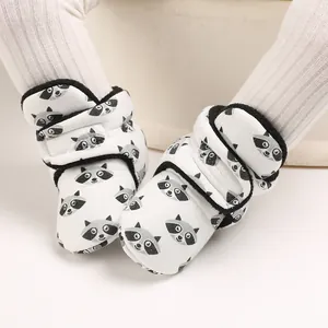 Detail of cute raccoon print baby booties with soft fabric and Velcro closure
