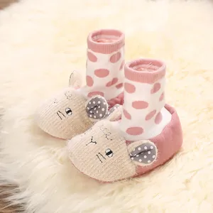 Detailed view of cute cartoon sheep baby shoes with soft soles on a furry rug