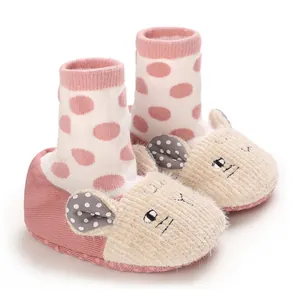 Close-up of cute pink cartoon mouse baby booties with warm fleece texture and soft soles