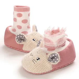 Detailed macro view of pink cartoon animal baby shoes featuring soft sole and warm fuzzy knit
