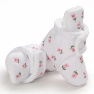 Detailansicht weißer gefütterter Babyschuhe mit zartrosa Blumenstickerei und Vlies