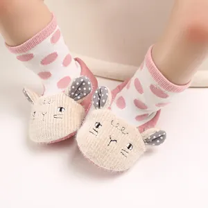 Close-up of cute pink cartoon lamb baby soft sole shoes on infant feet