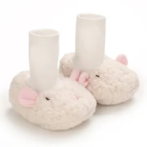 Detail view of white fuzzy sheep-style baby booties with pink ears and soft knitted sock cuffs