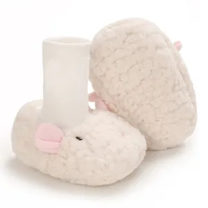 Detail of plush cartoon baby booties with soft white fleece and pink ears