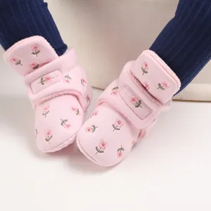 Detail der rosa geblümten Baby-Schneestiefel mit warmem Fleecefutter und Klettverschluss