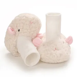Detailed view showing the soft fluffy texture of white baby sheep shoes with pink ears